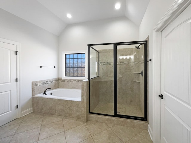 bathroom featuring tile patterned flooring, vaulted ceiling, and shower with separate bathtub