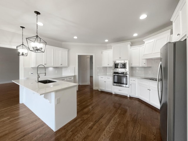 kitchen featuring sink, hanging light fixtures, stainless steel appliances, white cabinets, and kitchen peninsula