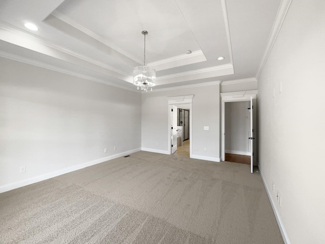 unfurnished bedroom featuring crown molding, a raised ceiling, a chandelier, and light carpet