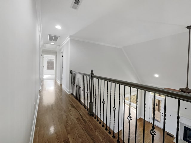 hallway featuring crown molding, vaulted ceiling, and dark hardwood / wood-style floors