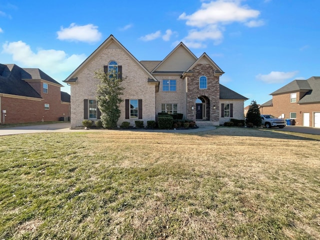 view of property featuring a front lawn