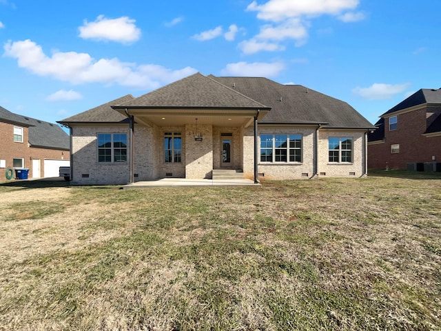 rear view of house with a yard and a patio