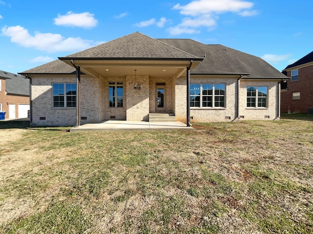 rear view of house with a patio and a lawn