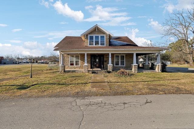 view of front facade with covered porch and a front yard