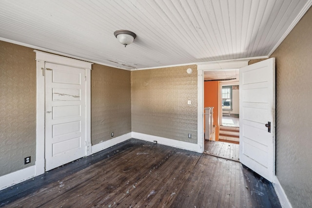 unfurnished bedroom with ornamental molding and dark hardwood / wood-style flooring