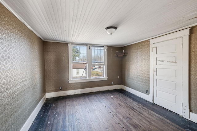 spare room with wood ceiling, dark hardwood / wood-style flooring, and crown molding