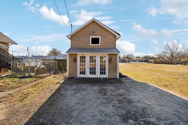 rear view of house featuring a yard and french doors