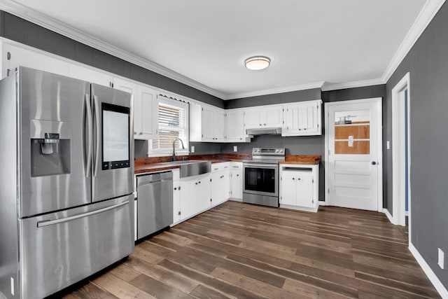 kitchen with sink, ornamental molding, dark hardwood / wood-style flooring, stainless steel appliances, and white cabinets