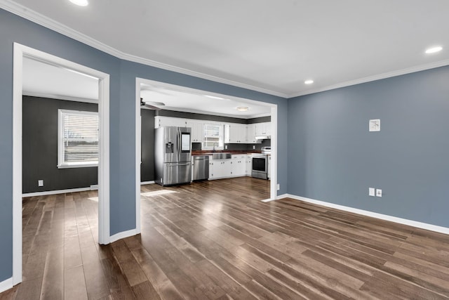 unfurnished living room with ornamental molding, dark hardwood / wood-style floors, and ceiling fan