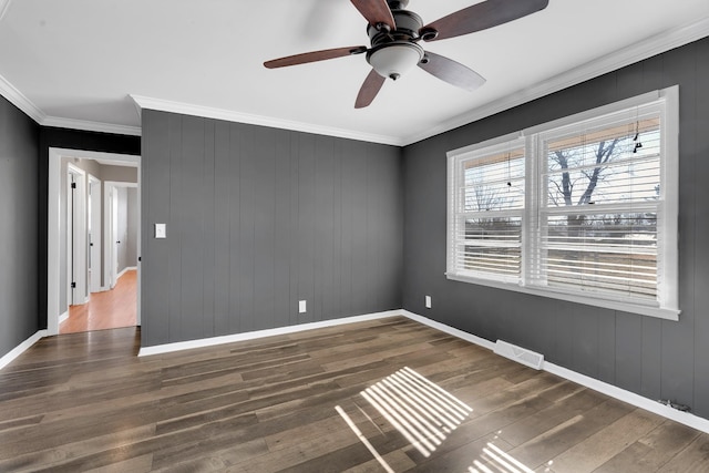 unfurnished room with ornamental molding and dark hardwood / wood-style floors