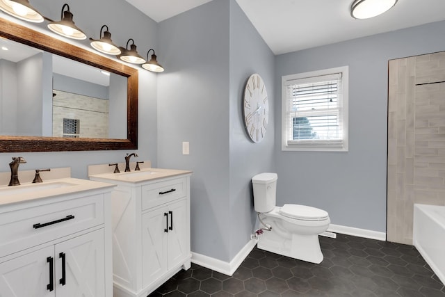 bathroom featuring vanity, tile patterned floors, and toilet