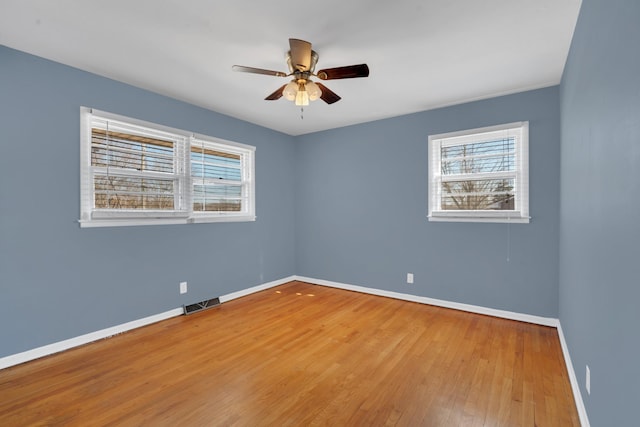 empty room with hardwood / wood-style flooring and ceiling fan