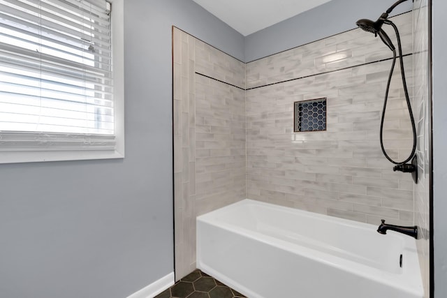 bathroom featuring tile patterned flooring and tiled shower / bath