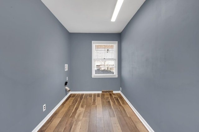 laundry room with wood-type flooring