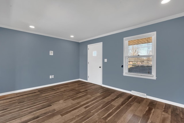 spare room with dark wood-type flooring and ornamental molding