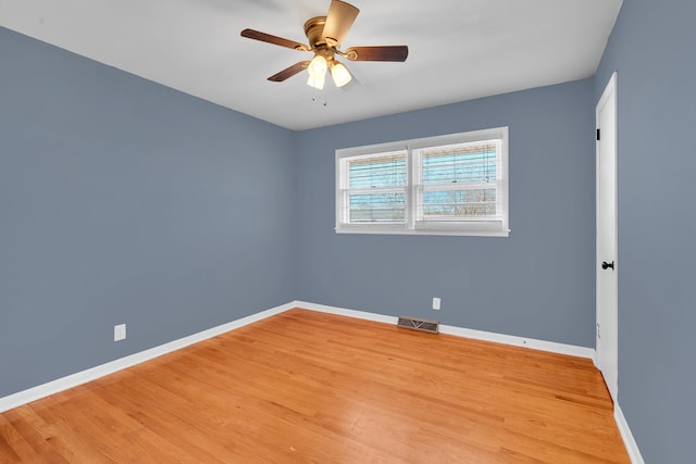 spare room featuring light hardwood / wood-style floors and ceiling fan