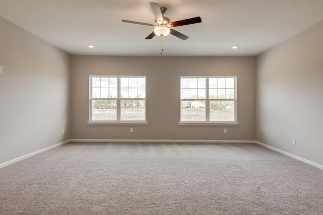 spare room featuring carpet floors and ceiling fan