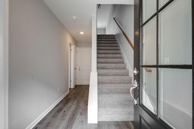 stairway with hardwood / wood-style flooring