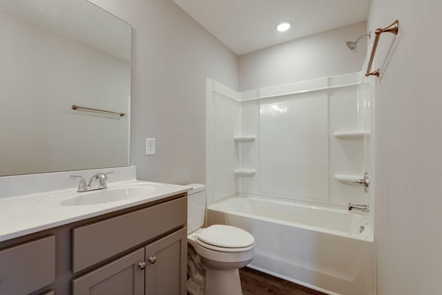 full bathroom with bathtub / shower combination, vanity, toilet, and wood-type flooring