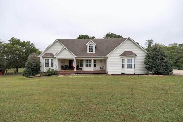 new england style home with a porch and a front yard