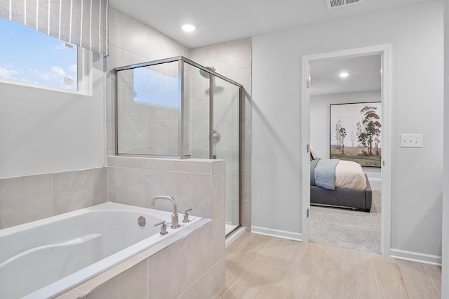 bathroom featuring separate shower and tub