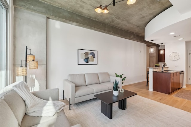 living room featuring sink and light wood-type flooring