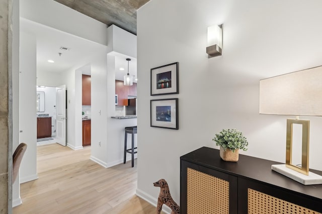 corridor with light hardwood / wood-style flooring