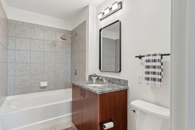 full bathroom with vanity, tiled shower / bath, tile patterned floors, and toilet