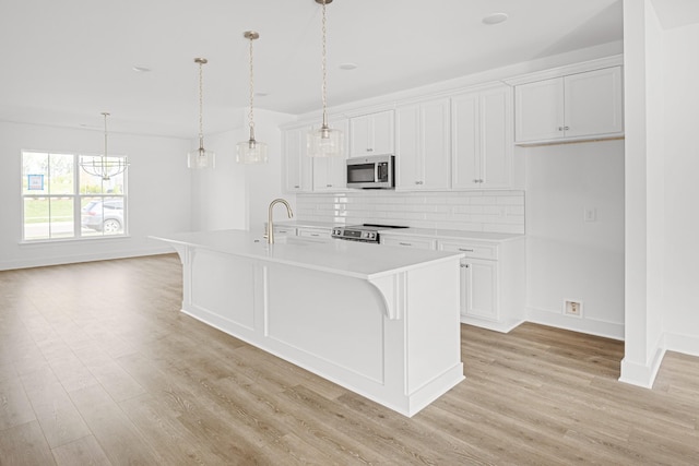 5061 Greentree Dr, Smyrna, TN 37167 - kitchen featuring stainless steel appliances, tasteful backsplash, light countertops, and light wood finished floors
