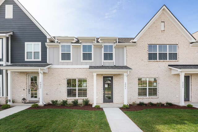 5061 Greentree Dr, Smyrna, TN 37167 - view of front facade with a front lawn, board and batten siding, and brick siding