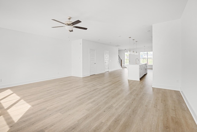 5061 Greentree Dr, Smyrna, TN 37167 - unfurnished living room with a sink, light wood-style flooring, baseboards, and ceiling fan