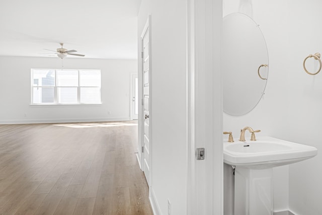 5061 Greentree Dr, Smyrna, TN 37167 - bathroom with wood finished floors, a ceiling fan, baseboards, and a sink