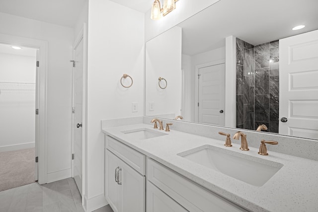 5061 Greentree Dr, Smyrna, TN 37167 - full bath with double vanity, a tile shower, baseboards, marble look tiles, and a walk in closet