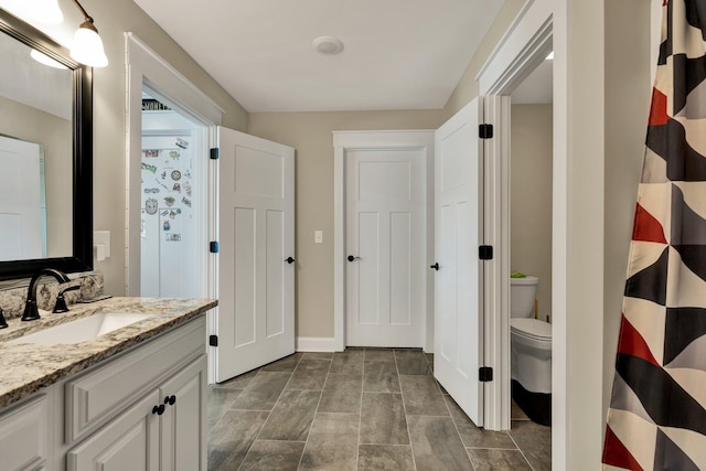 bathroom with vanity and toilet