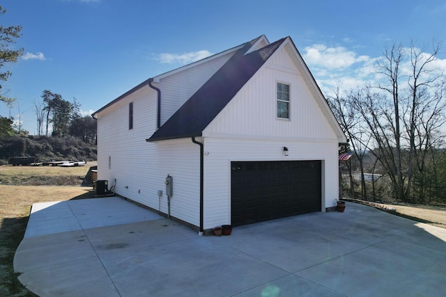 view of home's exterior featuring cooling unit and a garage