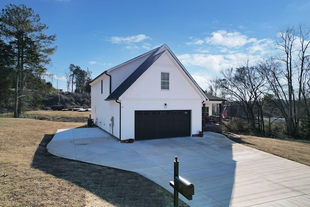 view of side of home with a garage and a yard