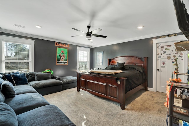 carpeted bedroom featuring ornamental molding and ceiling fan