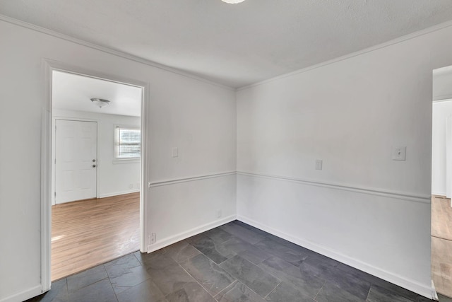 empty room featuring crown molding