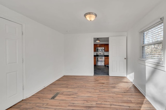 spare room featuring light hardwood / wood-style flooring