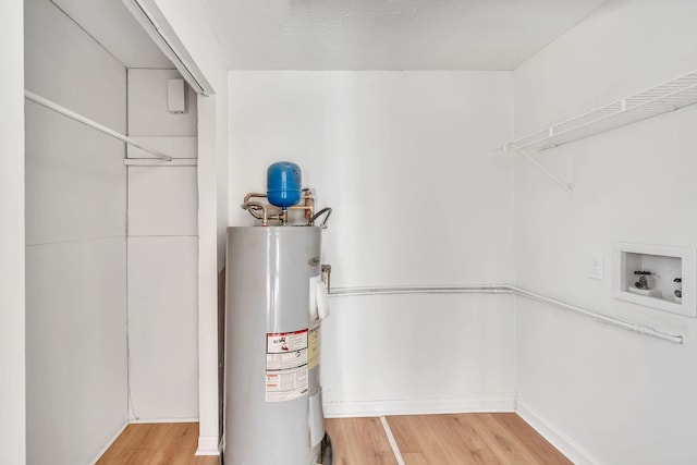 utility room featuring water heater