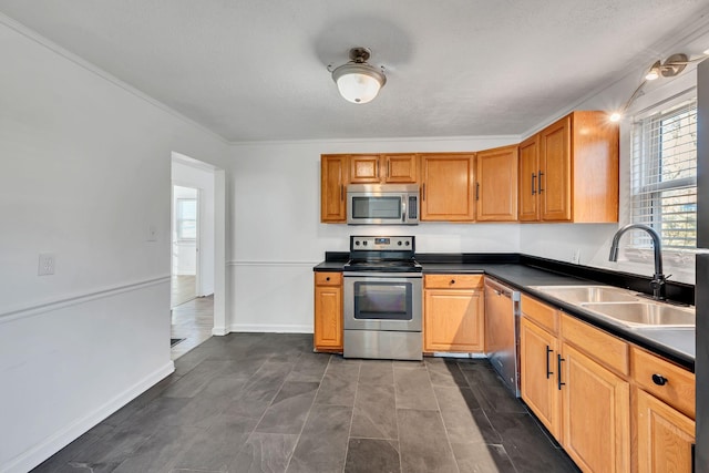 kitchen with stainless steel appliances, sink, and a textured ceiling