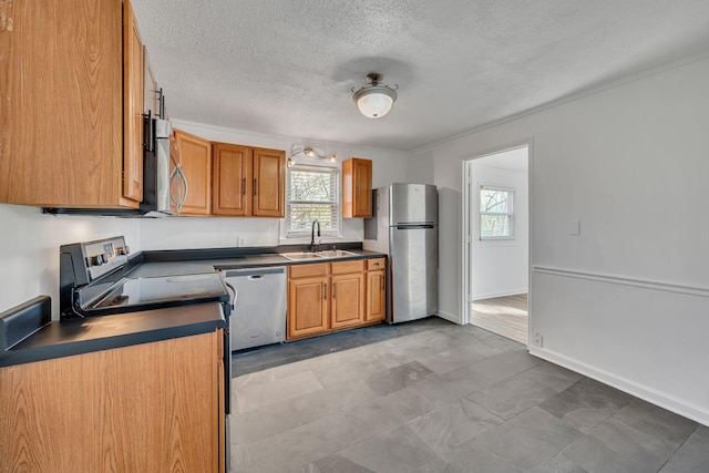 kitchen featuring sink, a textured ceiling, and appliances with stainless steel finishes