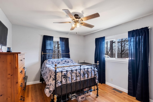 bedroom with wood-type flooring and ceiling fan