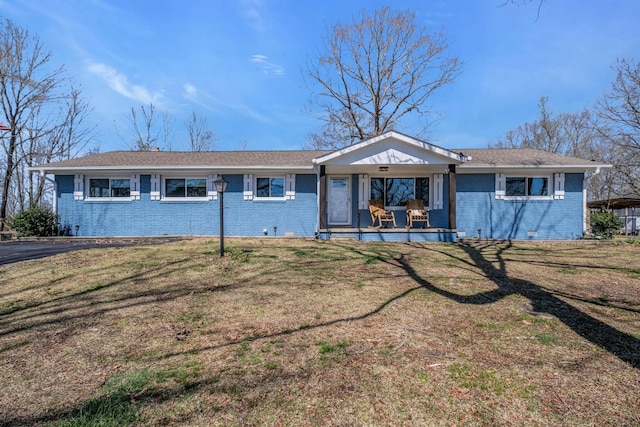 ranch-style house with covered porch and a front yard