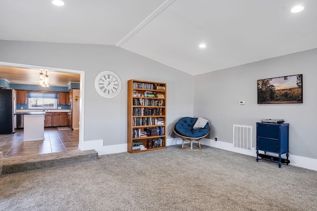 unfurnished room with lofted ceiling, sink, and dark colored carpet