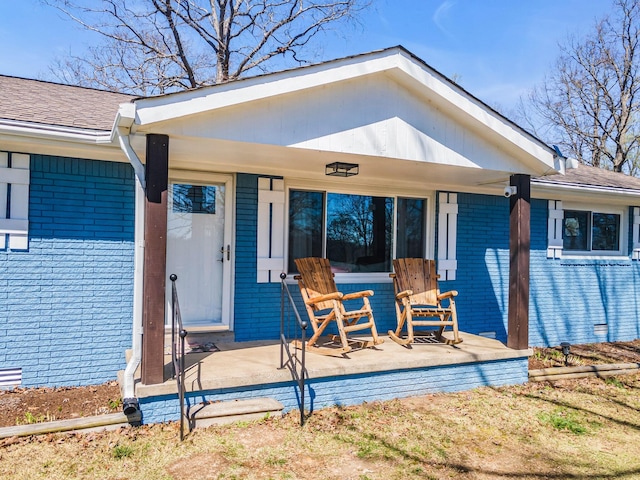 back of house featuring a porch