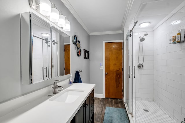 bathroom featuring an enclosed shower, vanity, hardwood / wood-style flooring, and ornamental molding