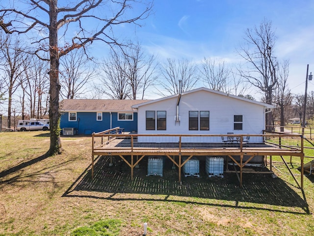 back of house with a yard and a deck