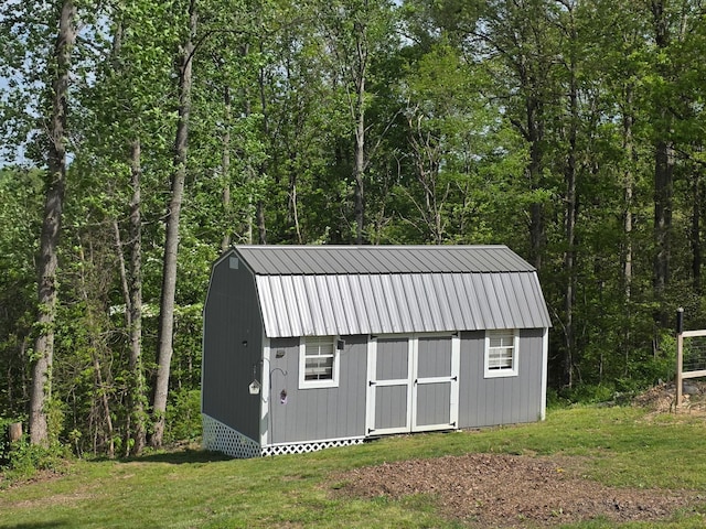 view of shed with a forest view