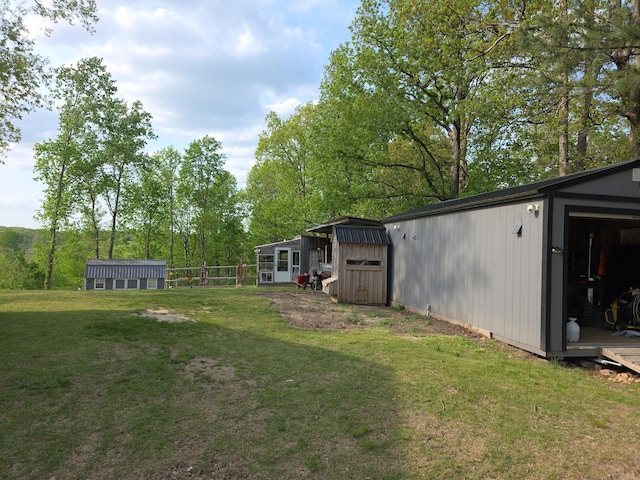 view of yard with an outdoor structure and a storage unit